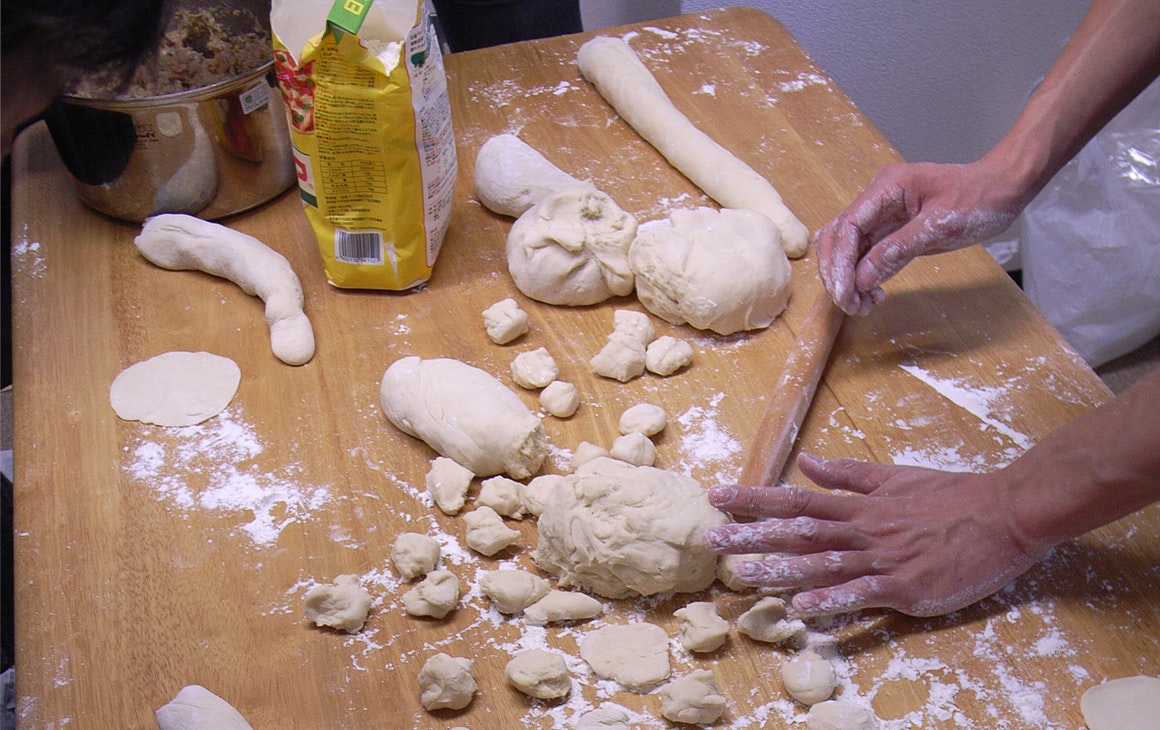 a person making pasta on a table